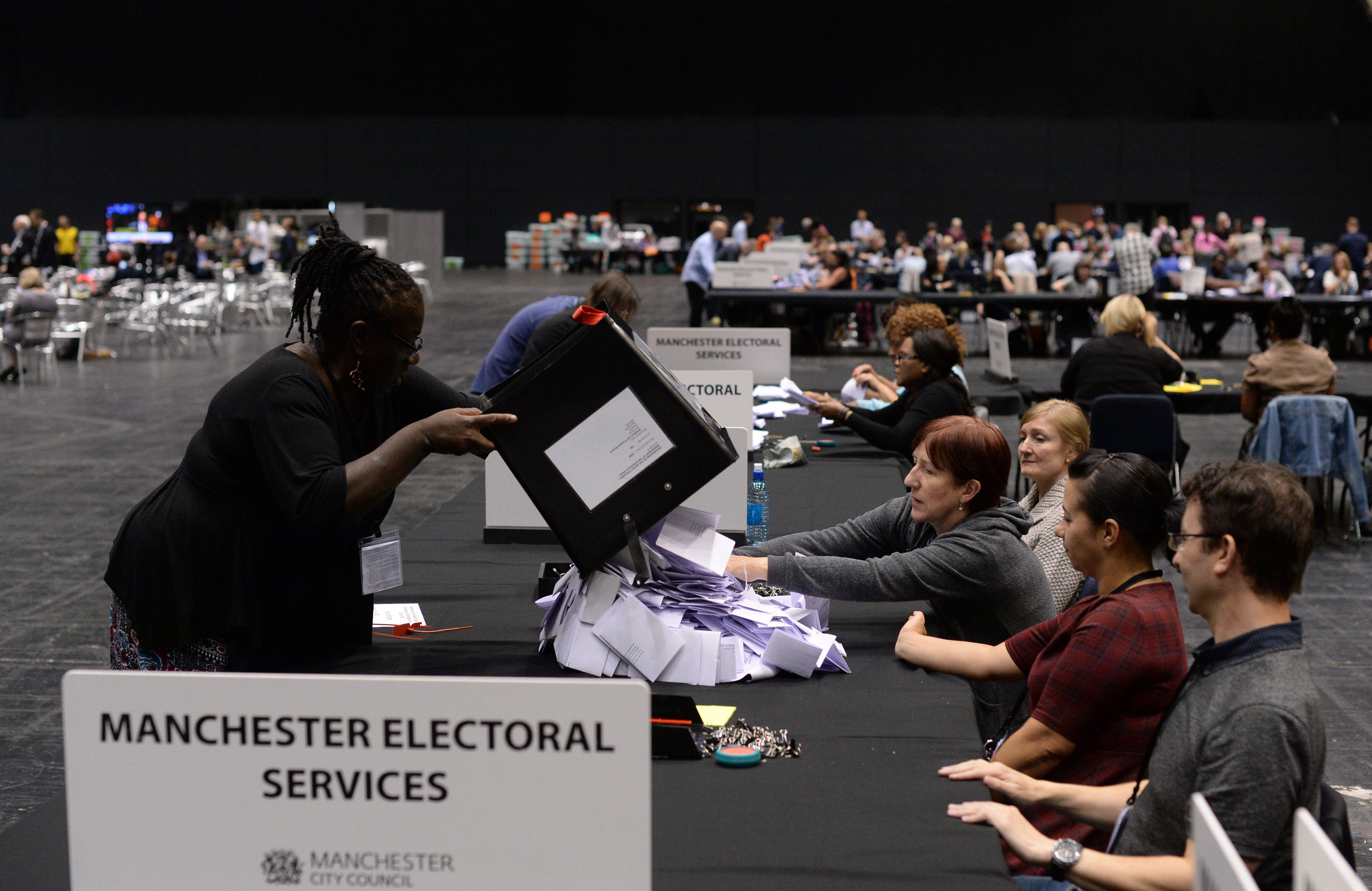 Election workers in the United Kingdom counting ballots following the country's vote on EU membership, June 24, 2015