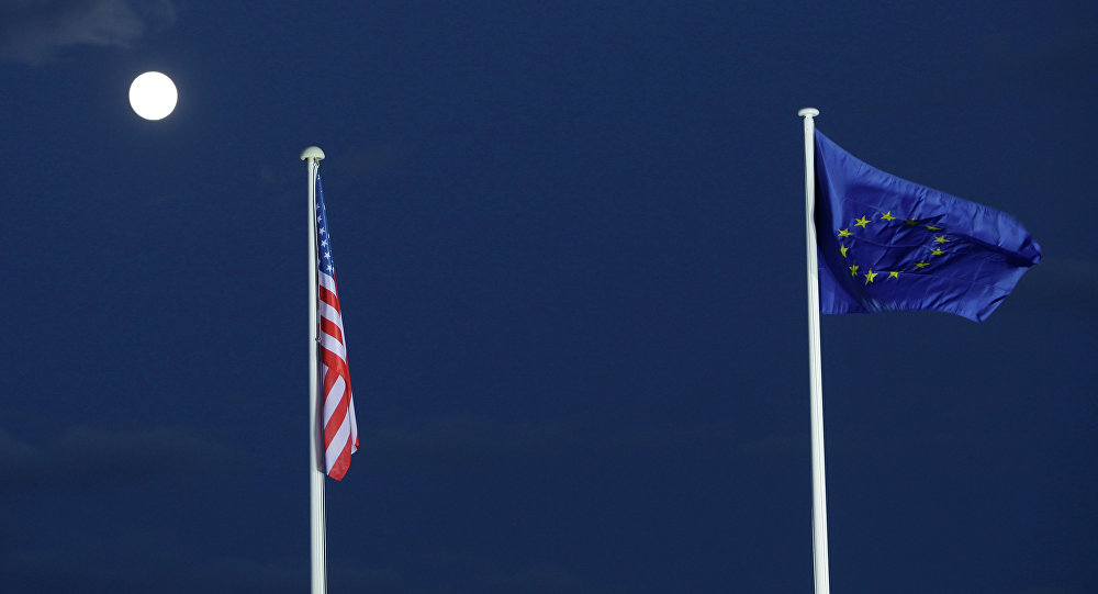 EU and US flags seen beneath the moon